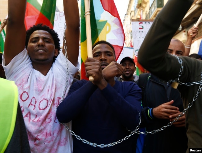FILE - Ethiopian migrants, all members of the Oromo community of Ethiopia living in Malta, protest in Valletta against the Ethiopian regime's plan to evict Oromo farmers to expand Ethiopia's capital, Addis Ababa, Dec. 21, 2015.