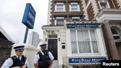 Police officers stand outside the City Stay Hotel used by two suspected Russian military intelligence agents — who have been accused of attempting to murder former Russian spy Sergei Skripal and his daughter Yulia — in London, Britain, Sept. 5, 2018. 
