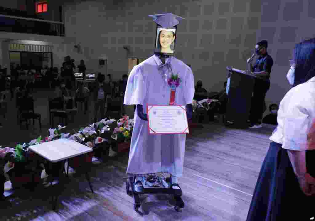 A picture of a student is seen on a tablet that is placed on a robot during an event they called &quot;cyber-graduation&quot; at a school at Taguig in Manila, Philippines.