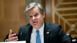 FBI Director Christopher Wray testifies before a Senate Homeland Security and Governmental Affairs Committee hearing to discuss security threats 20 years after the 9/11 terrorist attacks, Sept. 21, 2021 on Capitol Hill in Washington. 