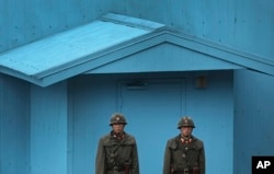 FILE - North Korean soldiers guard the truce village of Panmunjom at the Demilitarized Zone (DMZ) which separates the two Koreas.