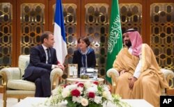 In this Nov. 9, 2017, photo released by Saudi Press Agency, SPA, Saudi Crown Prince Mohammed bin Salman meets with French President Emmanuel Macron upon his arrival in Riyadh, Saudi Arabia.