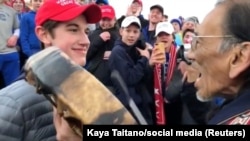 FILE - A student from Covington Catholic High School stands in front of Native American Vietnam veteran Nathan Phillips in Washington, Jan. 18, 2019, in this still image from video.