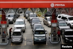 FILE - Motorists line up for fuel at a gas station of Venezuelan state-owned oil company PDVSA in Caracas, Venezuela, Sept. 21, 2017.