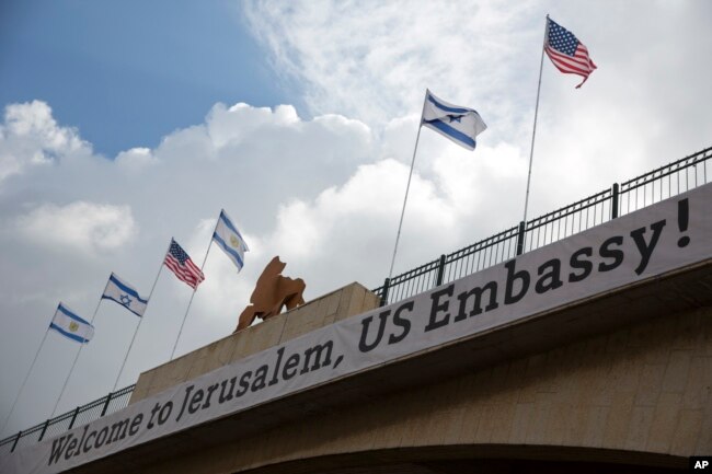 FILE - A sign is posted on a bridge leading to the U.S. Embassy compound ahead the official opening in Jerusalem, May 13, 2018.