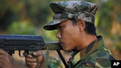 In this photo taken on Feb. 13, 2012, a Kachin soldier mans a frontline position, facing off against the Burmese government.