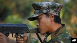 FILE - A Kachin soldier mans a frontline position, facing off against the Myanmar government.