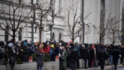 People gather outside Russia's Supreme Court ahead of consideration of a prosecutor's request to dissolve Memorial International, a human rights group, for allegedly violating a controversial law on "foreign agents," in Moscow, Nov. 25, 2021.