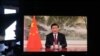 Chinese President Xi Jinping is seen on a TV screen speaking remotely at the opening of the WEF Davos Agenda virtual sessions at the WEF's headquarters in Cologny near Geneva on Jan. 17, 2022.