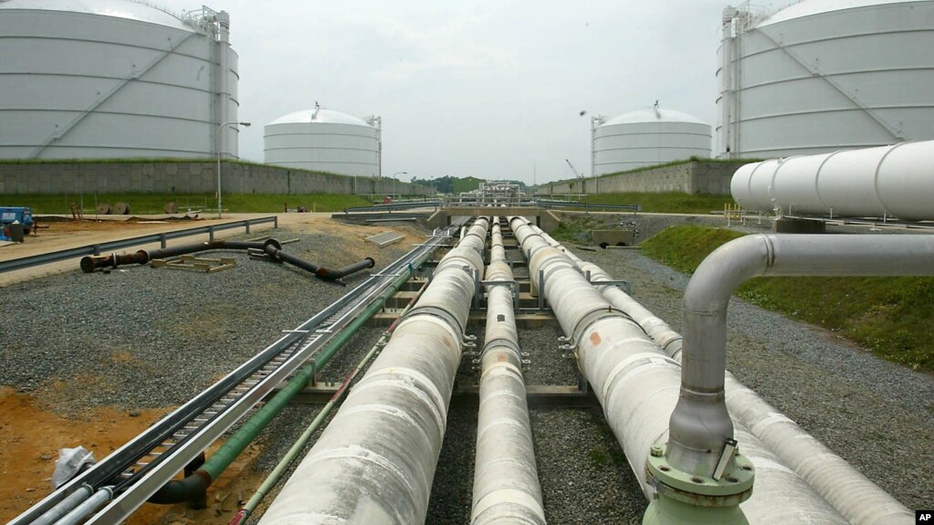 FILE - Pipelines running from the offshore docking station to four liquefied natural gas (LNG) tanks at the Dominion Resources Inc. Liquefied Natural Gas facility in Cove Point, Maryland.