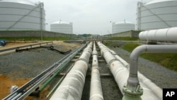 FILE - Pipelines running from the offshore docking station to four liquefied natural gas (LNG) tanks at the Dominion Resources Inc. Liquefied Natural Gas facility in Cove Point, Maryland.