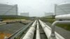 FILE - Pipelines running from the offshore docking station to four liquefied natural gas (LNG) tanks at the Dominion Resources Inc. Liquefied Natural Gas facility in Cove Point, Maryland, are seen in a June 13, 2003, photo.