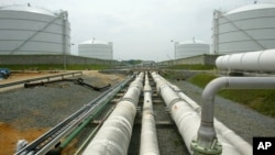 FILE - Pipelines running from the offshore docking station to four liquefied natural gas (LNG) tanks at the Dominion Resources Inc. Liquefied Natural Gas facility in Cove Point, Maryland, are seen in a June 13, 2003, photo.