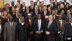 British Prime Minister David Cameron, bottom row third right, with delegates of London Conference on Somalia, Lancaster House, London, Feb. 23, 2012. Nations must help Somalia's fragile leadership tackle terrorism, piracy and hunger or be prepared to pay 