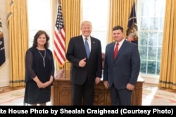 President Donald Trump welcomes State of the Union honored guest Jon Bridger, right, founder of the Cajun Navy, to the Oval Office at the White House, in Washington, Jan. 30, 2018.