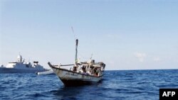 A handout picture from the Netherlands Ministry of Defense shows a boat containing alleged Somali pirates being apprehended by Dutch warship Evertsen. (File)