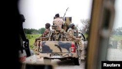 FILE - A Nigerian army convoy vehicle drives ahead with an anti-aircraft gun on its way to Bama, Borno State, Nigeria, Aug. 31, 2016.