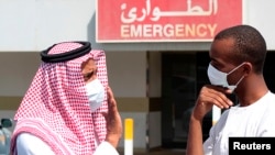 Men wear surgical masks as a precautionary measure against novel coronavirus, Dammam, Saudi Arabia, May 23, 2013.
