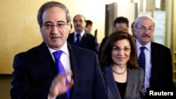 Syria's Deputy Foreign Minister Faisal Mekdad (L) leaves the headquarters of the Russian Foreign Ministry in Moscow, Nov. 18, 2013.