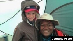 Montannah Kenney, 7, of Texas and her guide, Dismass, on their climb up Mt. Kilimanjaro in Tanzania. (Photo courtesy of Hollie Kenney)