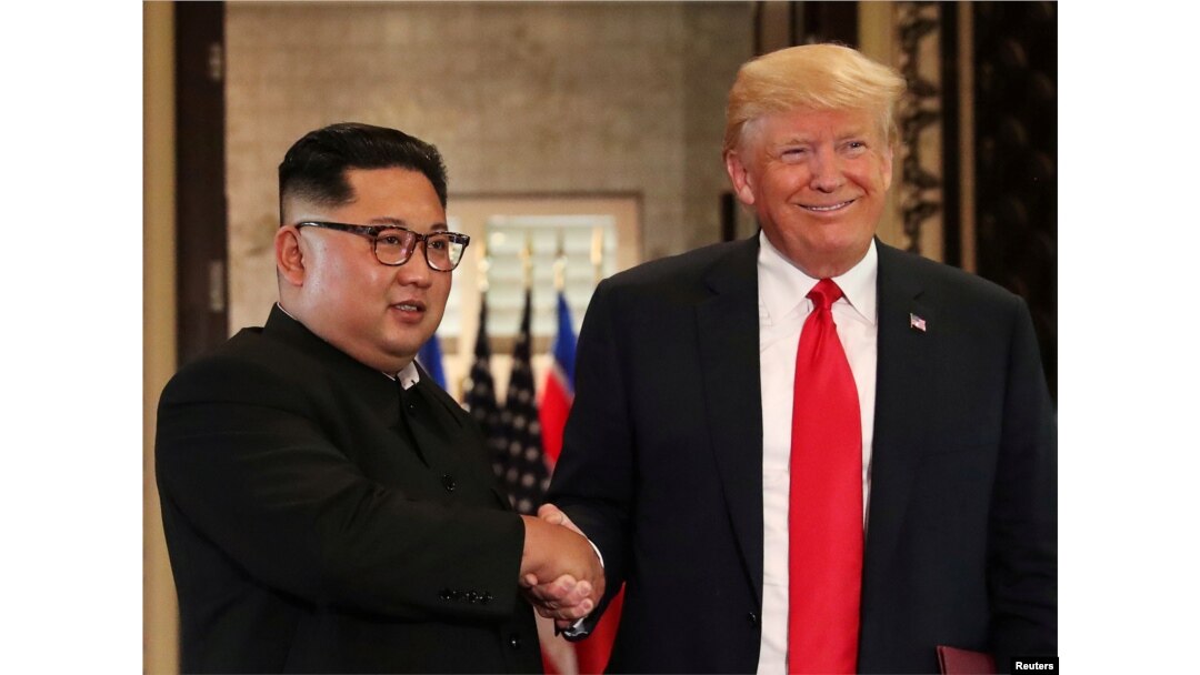 FILE - U.S. President Donald Trump and North Korean leader Kim Jong Un shake hands after signing documents during a summit at the Capella Hotel on the resort island of Sentosa, Singapore, June 12, 2018.