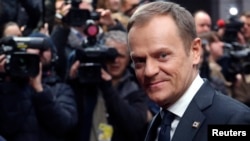FILE - Poland's Prime Minister Donald Tusk arrives at a European Union leaders summit in Brussels, March 21, 2014. 