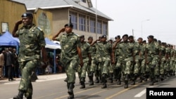 FILE - Soldiers from the Democratic Republic of Congo (DRC) take part in a parade to mark the country's Independence Day through a street in eastern city of Goma, June 30, 2014