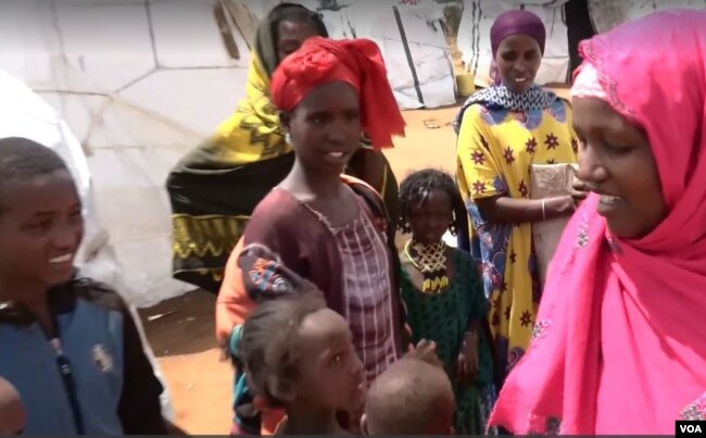 Abdiya Golicha, wearing pink, lives in northern Kenya's Marsabit County and volunteers to help Ethiopian refugees at the Dambala Fachana camp. (D. Gelmo/VOA)