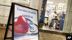 FILE - A pharmacy in New York City offers vaccines for COVID-19, flu, shingles and pneumonia, on Dec. 6, 2021.