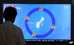 A man watches a TV screen showing a local news program reporting on North Korea's threats to strike Guam with ballistic missiles, at the Seoul Train Station in Seoul, South Korea, Aug. 10, 2017.