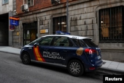 FILE - A police car is seen outside the police station where British businessman Bill Browder, a prominent critic of Russian President Vladimir Putin, was taken to when he was detained and then released by Spanish police in Madrid, May 30, 2018.