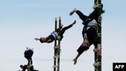 Members of the Edo Firemen Preservation Association perform Japanese traditional firefighting techniques during the New Year's fire brigades exercise in Tokyo on January 6, 2019.