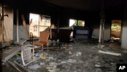 FILE - Glass, debris and overturned furniture are strewn inside a room in the gutted U.S. consulate in Benghazi, Libya, after an attack that killed four Americans, including Ambassador Chris Stevens, Sept. 12, 2012.