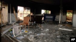 FILE - Glass, debris and overturned furniture are strewn inside a room in the gutted U.S. consulate in Benghazi, Libya, after an attack that killed four Americans, including Ambassador Chris Stevens, Sept. 12, 2012.