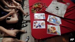 A group of sex workers are given a class on safe sex by members of an HIV/AIDS outreach network at a karaoke club, file photo. (AP Photo/David Guttenfelder)