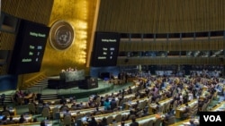 FILE - Voting results are shown on boards following a United Nations General Assembly vote to address the economic, commercial and financial embargo imposed by the U.S. against Cuba at the United Nations headquarters in New York, Oct. 27, 2015
