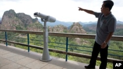  North Korea official So Myong Il introduces the rocky peaks around Mount Chilbo, North Korea. 