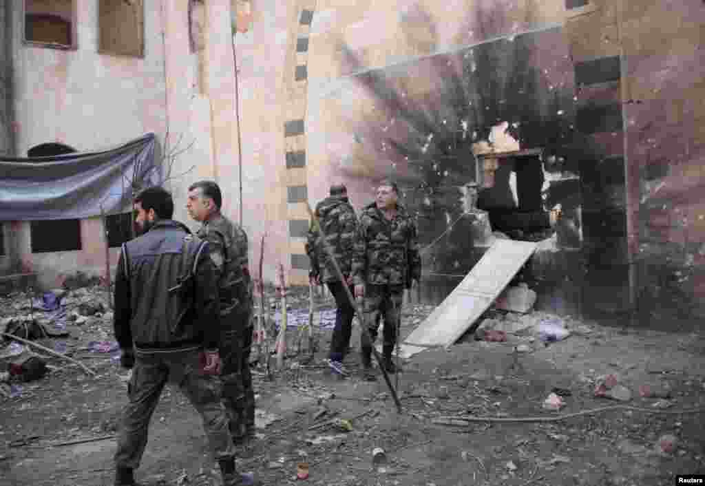 Forces loyal to Syria's President Bashar al-Assad walk in the old city of Aleppo, Feb. 11, 2014. 