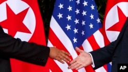 도널드 트럼프 미국 대통령(오른쪽)과 김정은 북한 국무위원장이 지난 6월 12일 싱가포르에서의 첫 정상회담에 앞서 악수하고 있다.