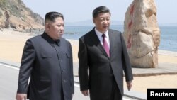 Chinese President Xi Jinping and North Korean leader Kim Jong Un meet in Dalian, Liaoning province, China in this picture released by Xinhua on May 8, 2018.