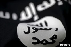 FILE - An Islamic State flag is seen in this photo illustration.