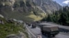 FILE - An Indian army convoy moves along the Srinagar-Ladakh highway at Gagangeer, northeast of Srinagar, Indian-administered Kashmir, Sept. 9, 2020. Control over the Ladakh border region is a key friction point between India and China.