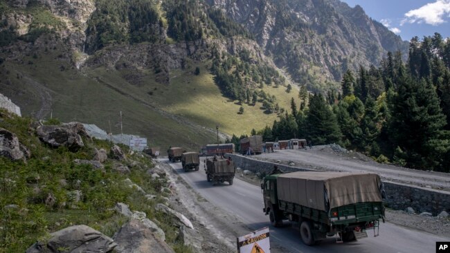 FILE - An Indian army convoy moves along the Srinagar-Ladakh highway at Gagangeer, northeast of Srinagar, Indian-administered Kashmir, Sept. 9, 2020. Control over the Ladakh border region is a key friction point between India and China.