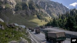 FILE - An Indian army convoy moves along the Srinagar-Ladakh highway at Gagangeer, northeast of Srinagar, Indian-administered Kashmir, Sept. 9, 2020. Control over the Ladakh border region is a key friction point between India and China.