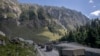 FILE - An Indian army convoy moves along the Srinagar-Ladakh highway at Gagangeer, northeast of Srinagar, Indian-administered Kashmir, Sept. 9, 2020. Control over the Ladakh border region is a key friction point between India and China.