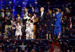 Democratic 2020 U.S. presidential nominee Joe Biden celebrates onstage at his election rally in Wilmington