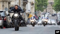 FILE - This image released by Paramount Pictures shows Tom Cruise in a scene from "Mission: Impossible - Fallout." Tom Cruise has outrun Winnie-the-Pooh at the box office. “Mission: Impossible -- Fallout” topped ticket sales for the second straight weekend with an estimated $35 million despite newcomer “Christopher Robin.” According to studio estimates Sunday, Aug. 5, 2018, the sixth “Mission: Impossible” installment has amassed $124 million in its first 10 days of release.