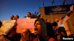 Protesters demand the release of what they say are political prisoners, outside the Cairo Opera house December 23, 2013.