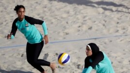 Egypt's Doaa Elghobashy, right, wears longer clothing and a hijab. This photo is from the 2016 Olympics in Brazil. (AP Photo/Marcio Jose Sanchez, File)