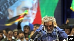 Afghan presidential candidate Abdullah Abdullah runs his hands through his hair as he pauses in addressing his supporters in Kabul, Afghanistan, Tuesday, July 8, 2014.